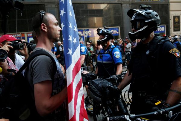 A demonstrator faces a police officer during protests outside the Republican National Convention in Cleveland, Ohio, July 19, 2016. REUTERS/Andrew Kelly