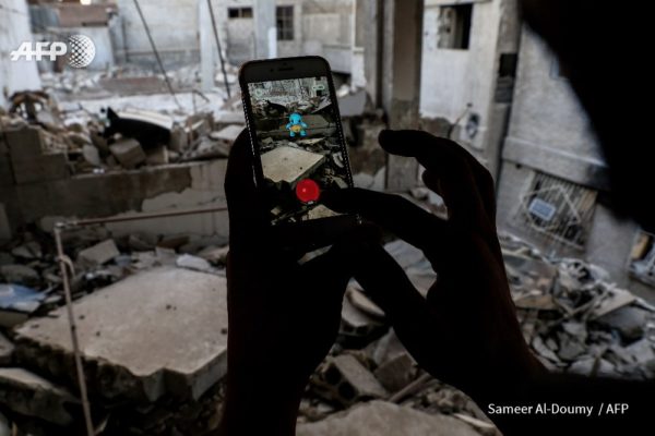 SYRIA - A gamer uses Pokemon Go application on mobile to catch a Pokemon amidst rubble in Douma. By @SameerAlDoumy/AFP