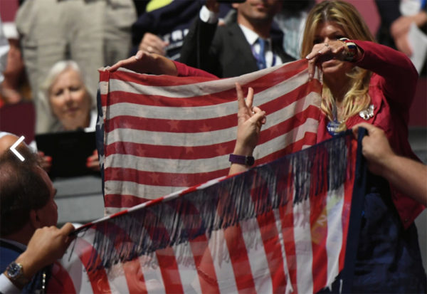 Toni L. Sandys / The Washington Post, “People use American flags to cover up the Code Pink protester.”