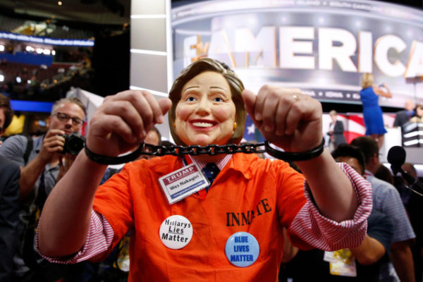 A Michigan delegate wears a Hillary Clinton mask during the Republican National Convention. Photo: EPA