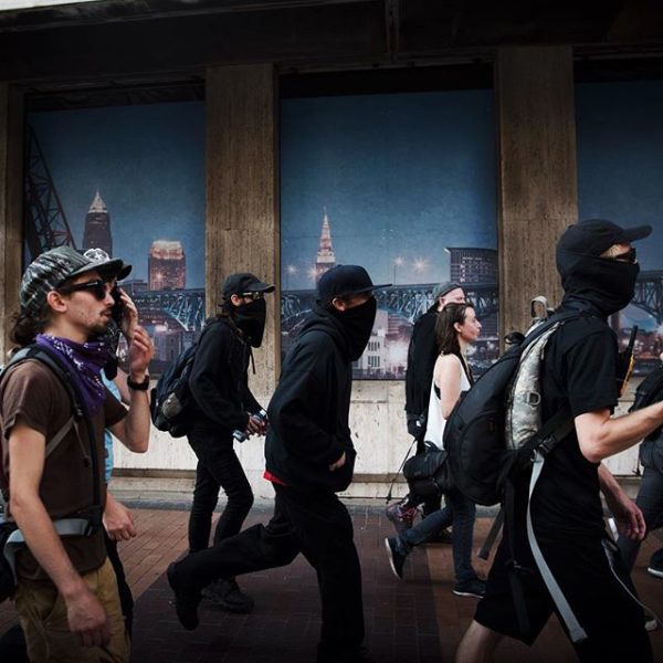 Anarchists march throughout downtown #Cleveland in an almost cat and mouse like fashion with police, ducking into alleyways and confronting the officers with questions of "Why can't we walk on the sidewalk." Hilary Swift/Instagram. On assignment with NY Times.
