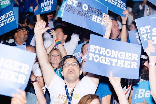Delegates cheered and booed throughout the night as Hillary Clinton's name was mentioned. Here, a Bernie supporter booed after Sanders announced his support of Clinton. He modified his "Stronger Together" sign to read "Stop Her." Photo by @mscottbrauer for @motherjonesmag 