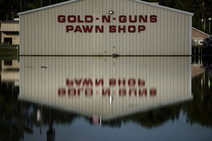photo: Brendan Smialowski / AFP / Getty. The Gold-N-Guns pawn shop is seen in floodwaters in Gonzales, Louisiana, on August 16, 2016.