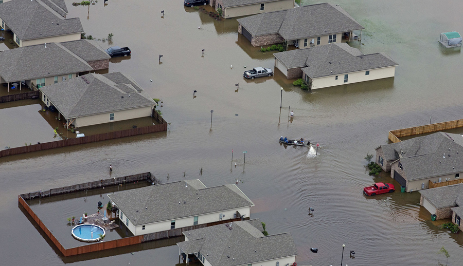 CREDIT: Max Becherer/AP. caption: In this aerial photo a boat motors between flooded homes after heavy rains inundating the region Saturday, Aug. 13, 2016, in Hammond, La. Louisiana Gov. John Bel Edwards says more than 1,000 people in south Louisiana have been rescued from homes, vehicles and even clinging to trees as a slow-moving storm hammers the state with flooding.