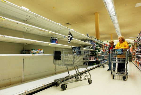 LONG BEACH, NY - OCTOBER 28: Connie of Long Beach grabs the few remaining water bottles from the shelves at the Waldbaums grocery store as Hurricane Sandy approaches on October 28, 2012 in Long Beach, New York. The storm, which could affect tens of millions of people in the eastern third of the U.S., is expected to bring days of rain, high winds and possibly heavy snow in parts of Ohio and West Virginia. New York Governor Andrew Cuomo announced that New York City will close its bus, subway and commuter rail service Sunday evening ahead of the storm. (Photo by Mike Stobe/Getty Images)