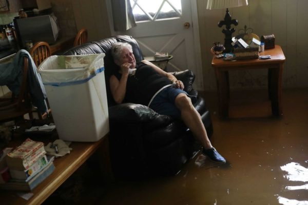 Joe Raedle/Getty Images. Elsie Lazarus in her flooded living room in St. Amant on Thursday. Almost 87,000 people in Louisiana have applied for federal aid as a result of the flooding.