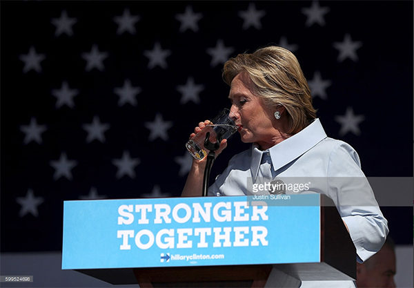 Democratic presidential nominee former Secretary of State Hillary Clinton pauses to take a drink of water to help soothe a cough during a campaign rally at Luke Easter Park on September 5, 2016 in Cleveland, Ohio. Clinton is kicking off a Labor Day campaign swing to Ohio and Iowa on a new campaign plane large enough to accommodate her traveling press corp. (Photo by Justin Sullivan/Getty Images)