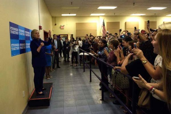 Democratic presidential nominee Hillary Clinton speaks to a crowd in an overflow room after a rally at Frontline Outreach and Youth Center September 21, 2016 in Orlando, Florida. / AFP / Brendan Smialowski