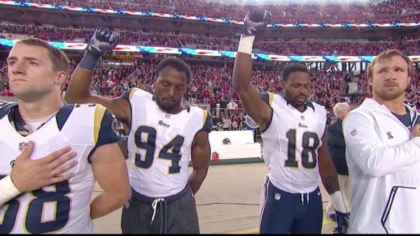 Rams defensive end Robert Quinn (No. 94) and wide receiver Kenny Britt (No. 18) stood with fists in the air during the national anthem. photo via SBNation.