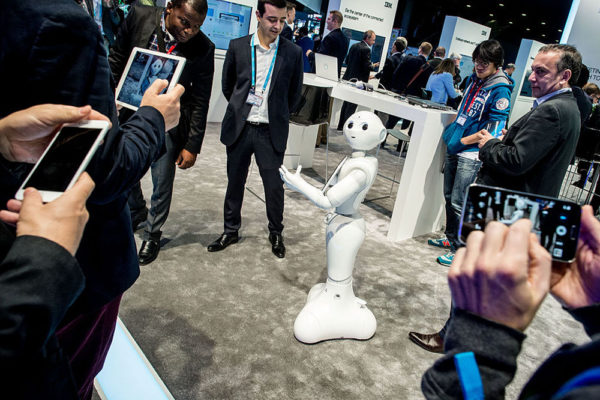 Visitors attend a demonstration of a robot named 'Pepper' at the IBM stand on day 3 of the Mobile World Congress 2016 on February 24, 2016 in Barcelona, Spain. The annual Mobile World Congress hosts some of the world's largest communications companies, with many unveiling their latest phones and wearables gadgets. Photo: David Ramos/Getty Images.