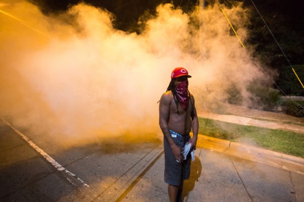 Protestors voiced frustrations to armored CMPD officers as they stand on Old Concord Road. Logan Cyrus/Charlotte Magazine