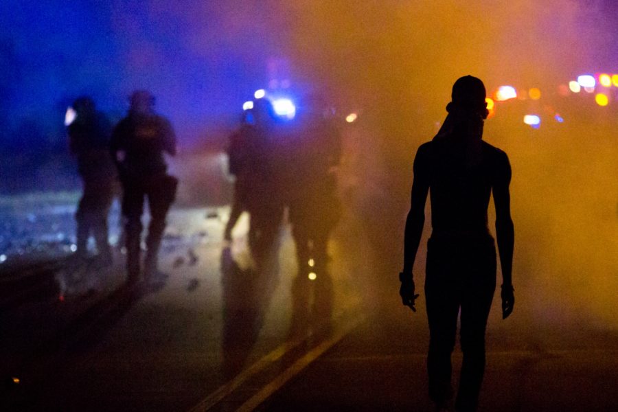 Protestors voiced frustrations to armored CMPD officers as they stand on Old Concord Road. Logan Cyrus/Charlotte Magazine