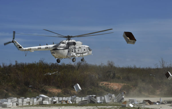 A UN helicopter lands next to aid sent by the United States for the people affected by Hurricane Matthew, in Jeremie, southwest of Port-au-Prince, Haiti, on October 10, 2016. Haiti's death toll from monster Hurricane Matthew has risen to 372, civil defense officials said Monday, as the impoverished country continues to dig out of massive destruction in the south. More than 175,500 people were staying in temporary shelters, days after the Caribbean's worst storm in nearly a decade slammed into Haiti last Tuesday. / AFP / Rodrigo ARANGUA (Photo credit should read RODRIGO ARANGUA/AFP/Getty Images)