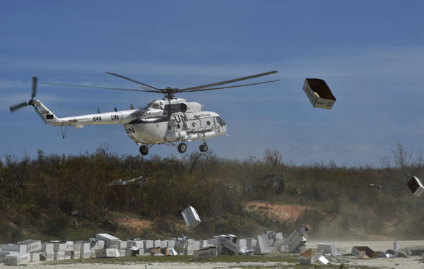 A UN helicopter lands next to aid sent by the United States for the people affected by Hurricane Matthew, in Jeremie, southwest of Port-au-Prince, Haiti, on October 10, 2016. Haiti's death toll from monster Hurricane Matthew has risen to 372, civil defense officials said Monday, as the impoverished country continues to dig out of massive destruction in the south. More than 175,500 people were staying in temporary shelters, days after the Caribbean's worst storm in nearly a decade slammed into Haiti last Tuesday. / AFP / Rodrigo ARANGUA (Photo credit should read RODRIGO ARANGUA/AFP/Getty Images)