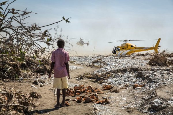 A young boy watches helicopters carrying politicians to the worst hit areas land in Roche-a-Bateau, southwestern Haiti, on Oct. 8, 2016 following Hurricane Matthew. Andrew McConnell—Panos