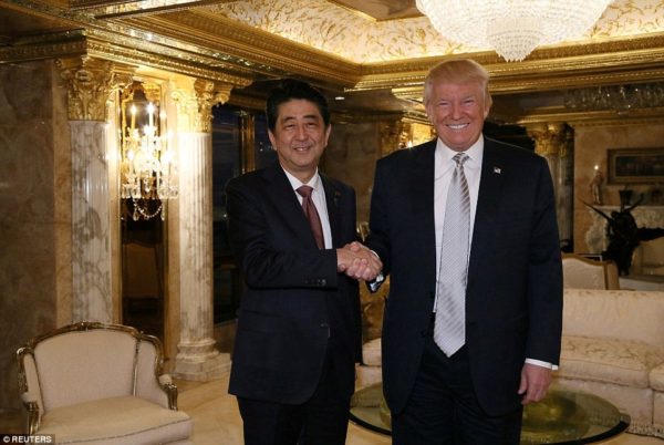 Meeting: Abe and Trump shake hands in what was the President-elect's first face-to-face meeting with a foreign leader. Handout via Reuters.