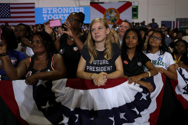 Justin Sullivan/Getty Images. caption: LAKE WORTH, FL - OCTOBER 26: Supporters listen as Democratic presidential nominee former Secretary of State Hillary Clinton speaks during a campaign rally at Palm Beach State College at Lake Worth on October 26, 2016 in Lake Worth, Florida. With less than two weeks to go until election day, Hillary Clinton and her surrogates continue to campaign in Florida and other battleground states. 