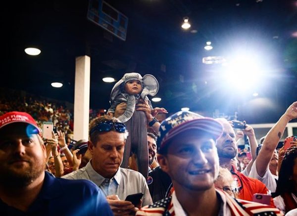  Photo: Evan Vucci caption: A supporter of Republican presidential candidate Donald Trump holds up a baby during a campaign rally in Sarasota, Florida. November 7, 2016.