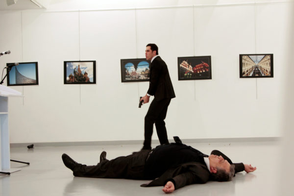 Photo 2: Reuters. Caption: A man, reported by The Associated Press to be the gunman, after the shooting of the Russian ambassador, on the floor, on Monday at a gallery in Ankara, the capital of Turkey.