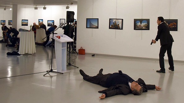  photo 2: STRINGER/AFP/Getty Images. Caption: Andrey Karlov (front), the Russian ambassador to Ankara, lies on the floor next to his killer who still point his gun to people attending an art exhibition in Ankara, on December 19, 2016. A gunman crying "Aleppo" and "revenge" shot Karlov while he was visiting an art exhibition in Ankara on December 19, witnesses and media reports said. The Turkish state-run Anadolu news agency said the gunman had been "neutralised" in a police operation, without giving further details. 