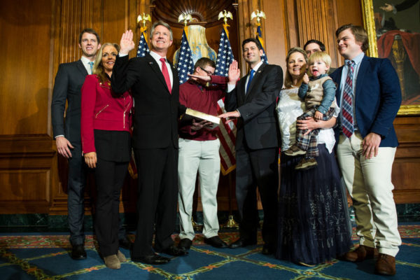Cal Marshall, center, dabs during the swearing-in of his father, Representative Roger Marshall of Kansas, center left, by House Speaker Paul D. Ryan, center right. The younger Mr. Marshall has been grounded. Credit Zach Gibson/Associated Press