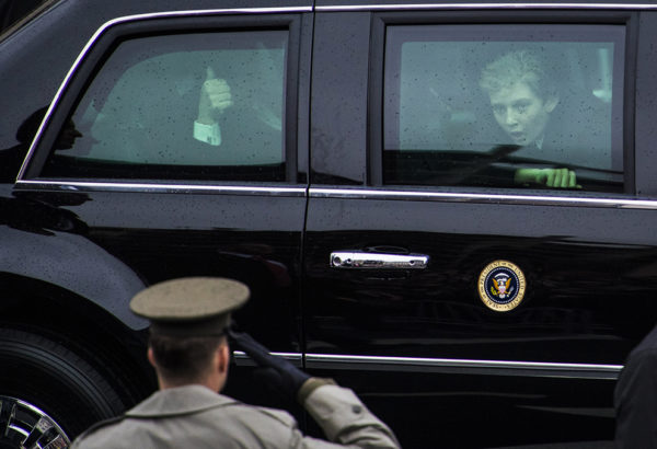 BARRON: WASHINGTON, DC - JANUARY 20: President Trump waves as his son Barron Trump looks out during the inaugural parade as it makes its way down Pennsylvania Avenue on Inauguration day in Washington, DC on Friday, Jan. 20, 2017.