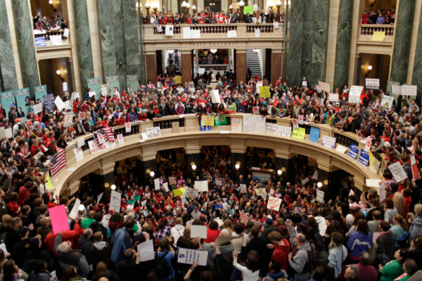 Narayan Mahon for The New York Times Caption: Angry public workers, facing cuts, crowded into the Capitol on Wednesday in Madison, Wisconsin