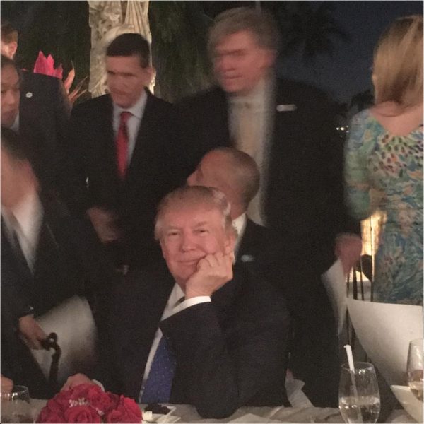 In this Instagram photo, we see Donald Trump at Mar-a-Lago smiling dreamingly while aides rush to his table to address a potential missile crisis with North Korea. photo: ebain529