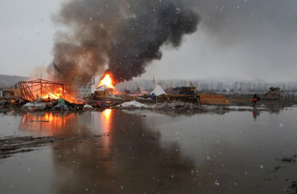 REUTERS/Terray Sylvester, Buildings burn after being set alight by protesters preparing to evacuate the main opposition camp against the Dakota Access oil pipeline near Cannon Ball, North Dakota.