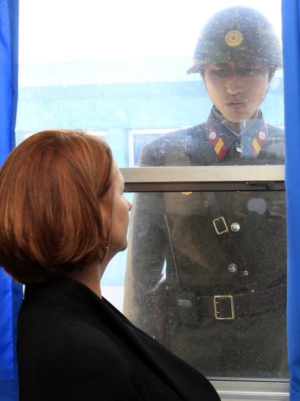 Prime Minister Julia Gillard (left) and a North Korean soldier look at each other through the window of the UN Command Military Armistice Commission meeting room at the border village of Panmunjom in the Demilitarised Zone (DMZ) that separates the two Koreas since the Korean War, April 24, 2011. Pool/Lee Jin-Man: AFP