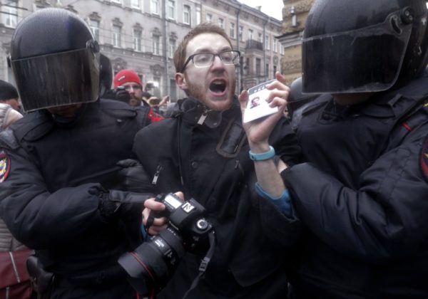 St. Petersburg Riot policemen detain a journalist during a protest rally. Dmitri Lovetsky/AP