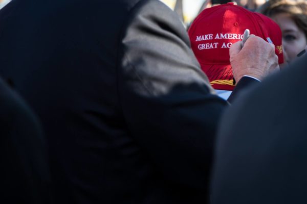President Donald Trump signs a hat for a greeter on Friday, Feb. 3, 2017, after arriving at the Palm Beach International Airport in Palm Beach, Florida. (Official White House Photo by Shealah Craighead)