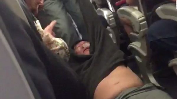 Screenshot of United Airlines passenger David Dao being removed from a plane by force after the airline overbooked the flight. Screenshot: Jayce David/Twitter.