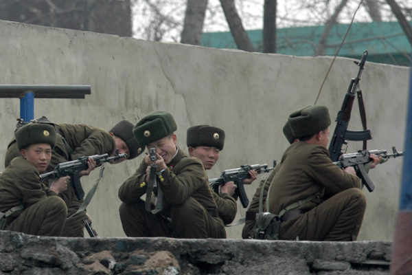 A North Korean soldier points his weapon at the photographer as he trains on the bank of the Yalu River in the North Korean town of Sinuiju, on December 19, 2006. Adam Dean / Reuters