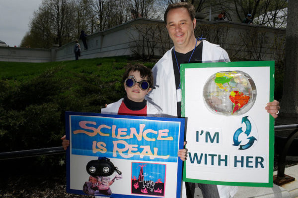 Miles Toppen, left, attended the Chicago march with his father Trevor Toppen. Credit: Joshua Lott for The New York Times