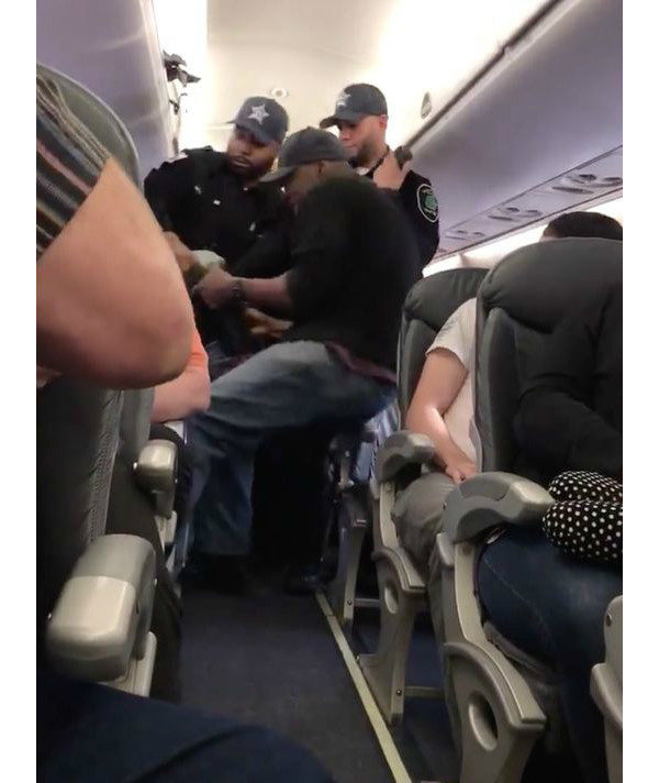 A United Airlines passenger is forcibly removed from an oversold flight in April, 2017. Screenshot via video by Audra Bridges.