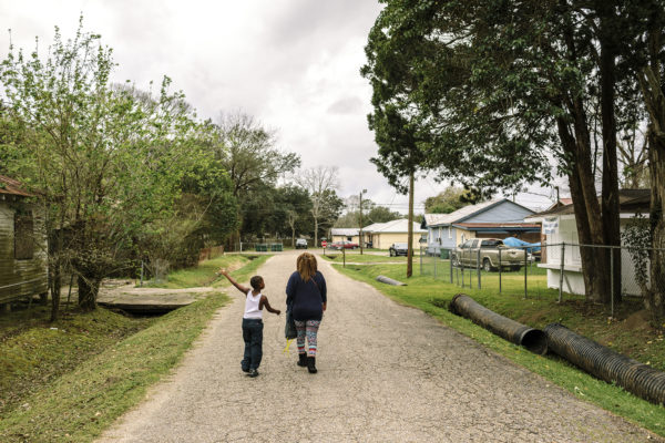 Reserve, LA - Feb 20, 2017 - A young boy walks home from school along Robinet Drive, one block from the fenceline of the Dupont/Denka plant.