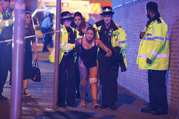 Police officers helping an injured concertgoer. Credit Rex Features, via Associated Press Photo