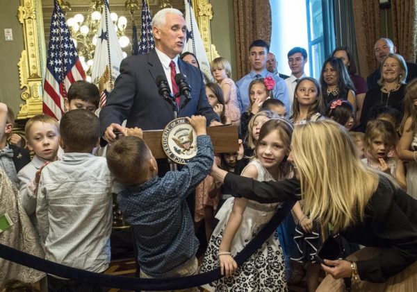 A young guest tries to remove the seal from the lectern as Vice President Mike Pence delivers remarks during and event with military families to celebrate National Military Appreciation Month and National Military Spouse Appreciation Day in the Eisenhower Executive Office Building May 9, 2017 in Washington, DC. The vice president hosted about 160 spouses and children of active duty U.S. military members. (May 8, 2017 - Source: Chip Somodevilla/Getty Images North America)