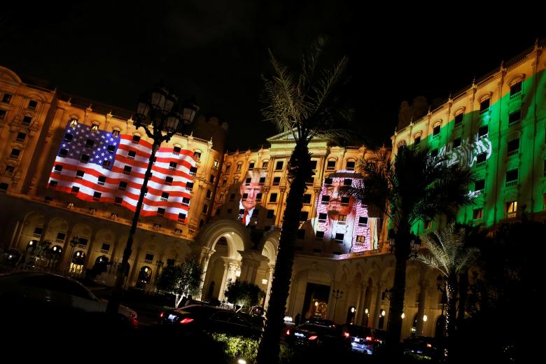 Pictures of President Donald Trump and Saudi Arabia's King Salman bin Abdulaziz Al Saud are projected on the front of the Ritz-Carlton, where Trump is staying in Riyadh. REUTERS/Jonathan Ernst