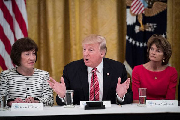 President Donald Trump, center, speaks as he meets with Republican senators about health care in the East Room of the White House of the White House in Washington, DC on Tuesday, June 27, 2017. Seated with him are Sen. Susan Collins, R-Maine, left, and Sen. Lisa Murkowski, R-Alaska, right, (Photo by Jabin Botsford/The Washington Post via Getty Images)