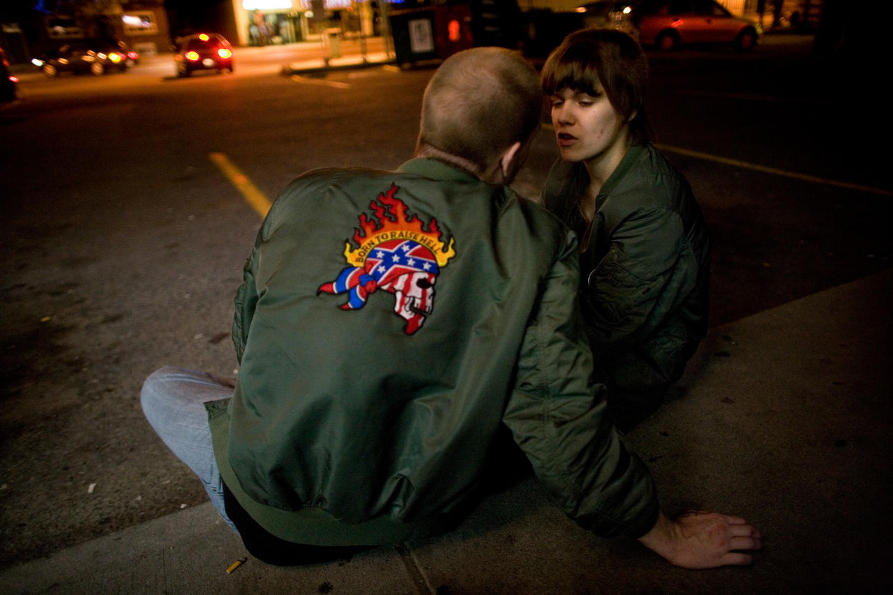 Richard and Izzy talk in front of a local Pizza shop, June, 2009. Toronto, Canada. Many relationships happened within these neo-nazi skinhead groups, which also led to a lot of conflict. Photo: Brett Gundlock