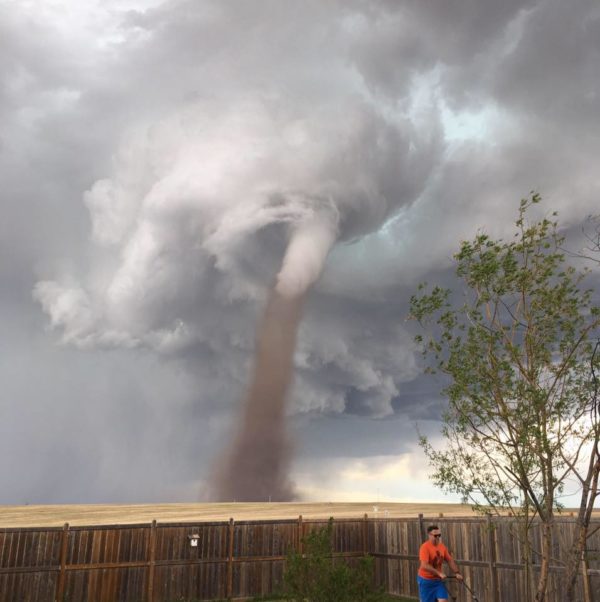 Photo: Cecilia Wessels/Canadian Press via Facebook . Washington Post caption: Theunis Wessels mowed his lawn at his home in the Canadian town of Three Hills, Alberta, on Friday as a tornado touched down nearby. The photo caused a bit of a storm on social media.
