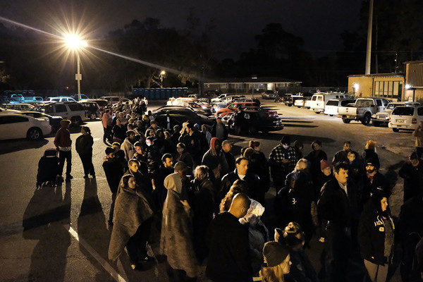 People gather at dawn, most after sleeping in their cars, to see a doctor at the Remote Area Medical (RAM) mobile dental and medical clinic on December 4, 2016 in Milton, Florida. More than a thousand people were expected seeking free dental and medical care at the two-day event in the financially struggling Florida panhandle community. RAM provides free medical care through mobile clinics in underserved, isolated, or impoverished communities around the country and world. As health-care continues to be a contentious issue in the U.S., an estimated 29 million Americans, about one in 10, lack coverage. Spencer Platt/Getty Images.