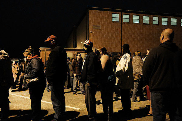 People gather at dawn, most after sleeping in their cars, to see a doctor at the Remote Area Medical (RAM) mobile dental and medical clinic on December 4, 2016 in Milton, Florida. More than a thousand people were expected seeking free dental and medical care at the two-day event in the financially struggling Florida panhandle community. RAM provides free medical care through mobile clinics in underserved, isolated, or impoverished communities around the country and world. As health-care continues to be a contentious issue in the U.S., an estimated 29 million Americans, about one in 10, lack coverage. Spencer Platt/Getty Images.
