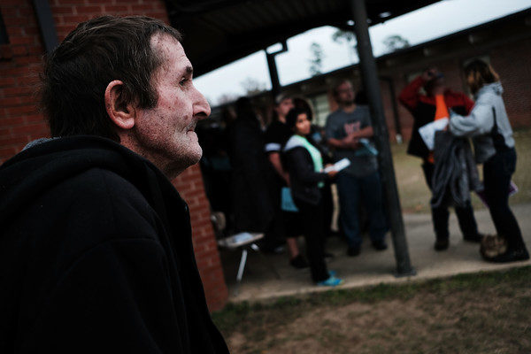 People gather at dawn, most after sleeping in their cars, to see a doctor at the Remote Area Medical (RAM) mobile dental and medical clinic on December 4, 2016 in Milton, Florida. More than a thousand people were expected seeking free dental and medical care at the two-day event in the financially struggling Florida panhandle community. RAM provides free medical care through mobile clinics in underserved, isolated, or impoverished communities around the country and world. As health-care continues to be a contentious issue in the U.S., an estimated 29 million Americans, about one in 10, lack coverage. Spencer Platt/Getty Images.