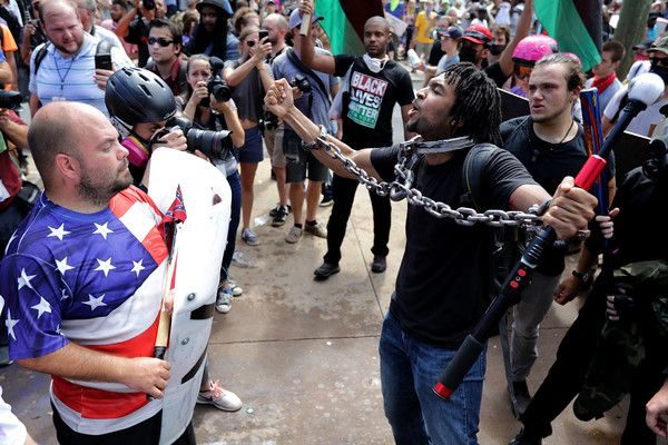 Photo: Chip Somodevilla/Getty Images. Caption: CHARLOTTESVILLE, VA – AUGUST 12: White nationalists, neo-Nazis and members of the ‘alt-right’ exchange insluts with counter-protesters as they attempt to guard the entrance to Emancipation Park during the ‘Unite the Right’ rally August 12, 2017 in Charlottesville, Virginia. After clashes with anti-fascist protesters and police the rally was declared an unlawful gathering and people were forced out of Emancipation Park, where a statue of Confederate General Robert E. Lee is slated to be removed.