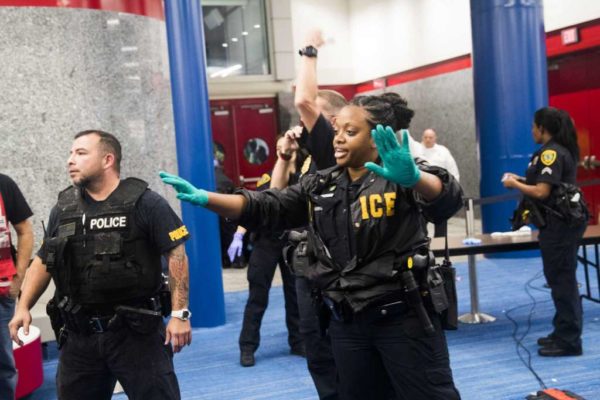 Photo: Marie D. De Jesus, Houston Chronicle A law enforcement officer asks people at the George R. Brown to make space to allow EMT to tend to a medical emergency, Monday, Aug. 28, 2017, in Houston.