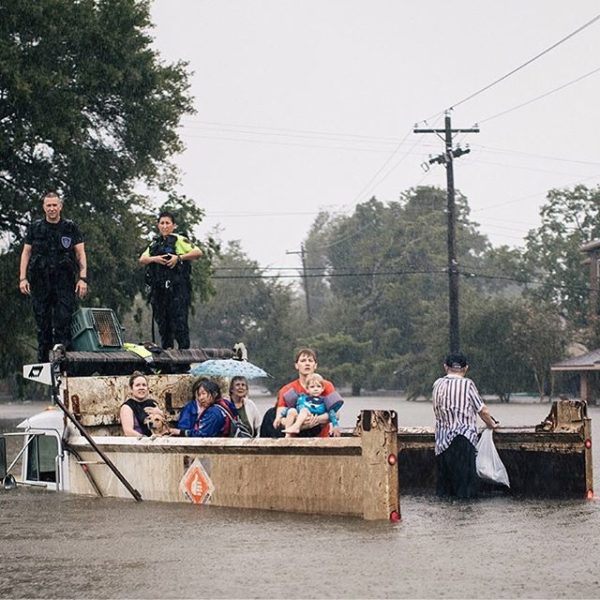 Rescue workers and civilians waited for emergency crews in the Meyerland area of Houston. Credit Alyssa Schukar for The New York Times
