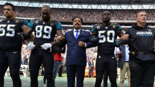 photo: Jacksonville Jaguars via Twitter. Caption: Several NFL players took a knee or locked arms on Sunday during the National Anthem of the first game since President Donald Trump began his crusade against such protests. The game between the Baltimore Ravens and Jacksonville Jaguars took place Wembley Stadium in London. Among those who participated in the protest was Jaguars owner Shahid Khan, who locked arms with tight end Mercedes Lewis and linebacker Telvin Smith. 